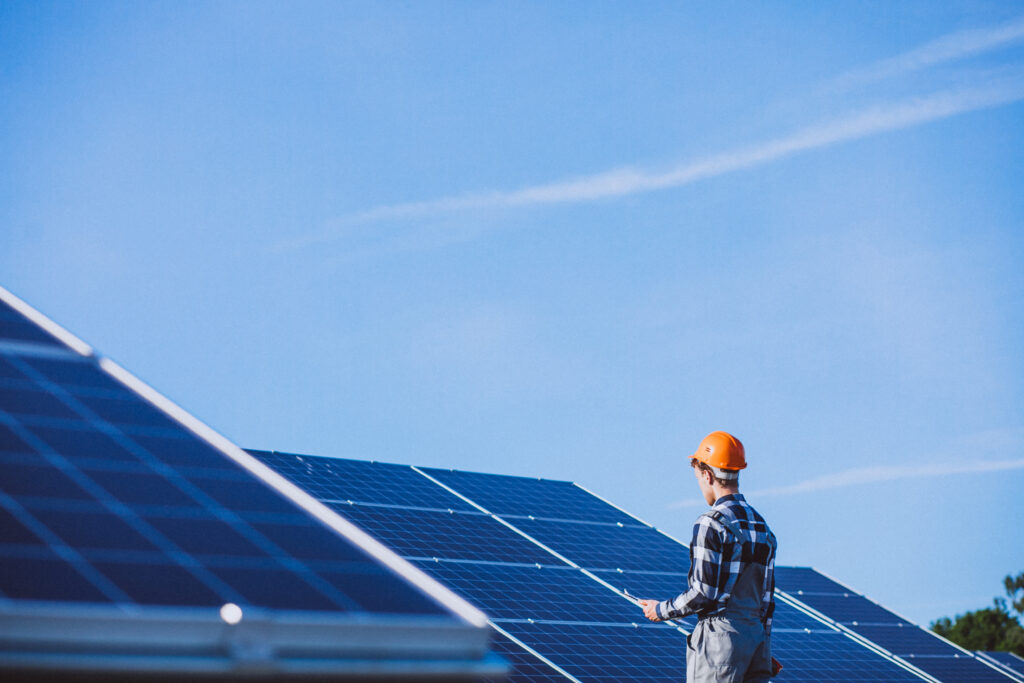 man worker firld by solar panels
